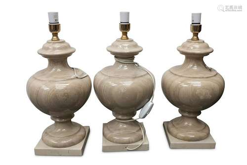 A set of three beige marble table lamp bases