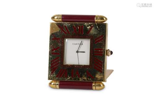 A Cartier lacquered brass and burgundy mounted travel