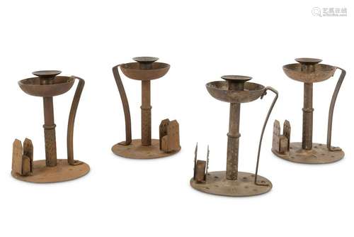 Four Arts and Crafts wrought iron candlesticks and