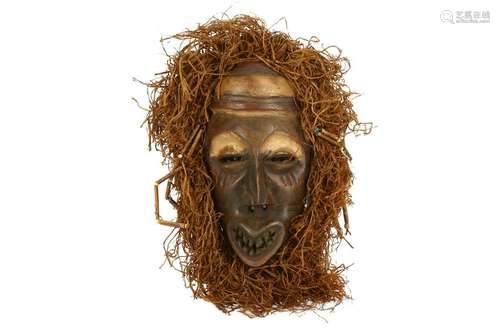 A FRINGED WOOD MASK