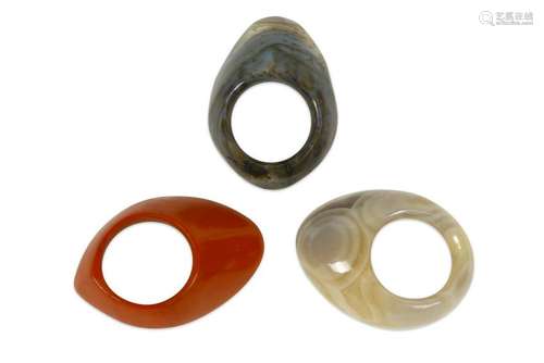 THREE CARVED HARDSTONE ARCHERS' RINGS