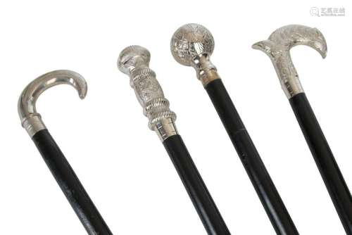 A collection of four chrome handled walking sticks