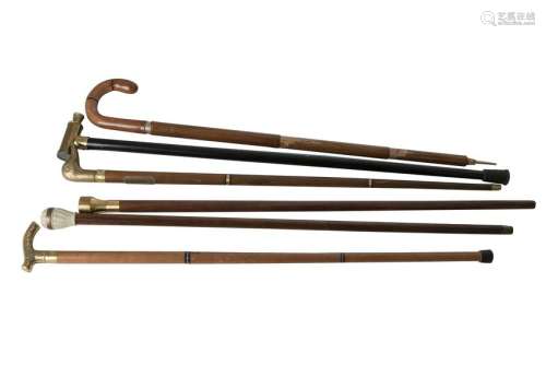 Six novelty walking sticks, two with drinking flasks,