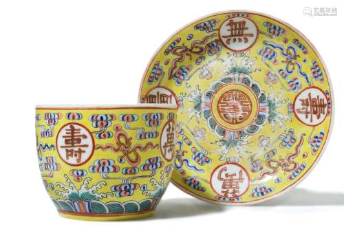 A CHINESE FAMILLE ROSE YELLOW-GROUND 'BIRTHDAY' CUP AND SAUCER.