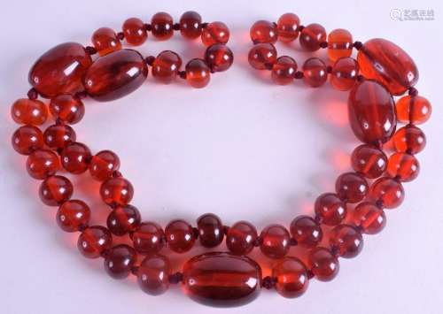 A 1920S RED AMBER TYPE NECKLACE. 290 grams. 110 cm