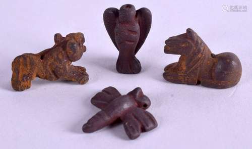 FOUR MINIATURE CENTRAL ASIAN BRONZE IDOLS. 2 cm wide.