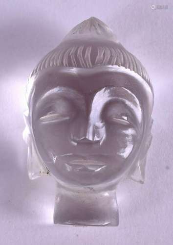 A CARVED CRYSTAL HEAD OF A BUDDHA. 3 cm x 1.5 cm.