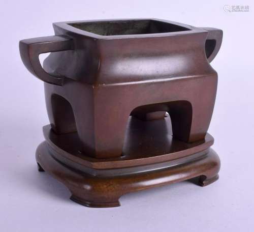 A CHINESE TWIN HANDLED BRONZE CENSER ON STAND. 15 cm