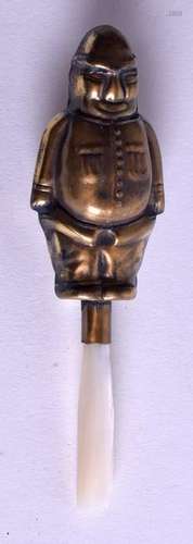 A BRASS SOLDIER RATTLE. 11.5 cm long.