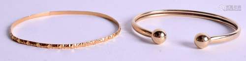 A 9CT GOLD BANGLE together with another yellow metal