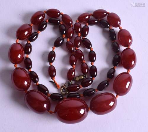 TWO CHERRY AMBER NECKLACES. 76 grams. (2)