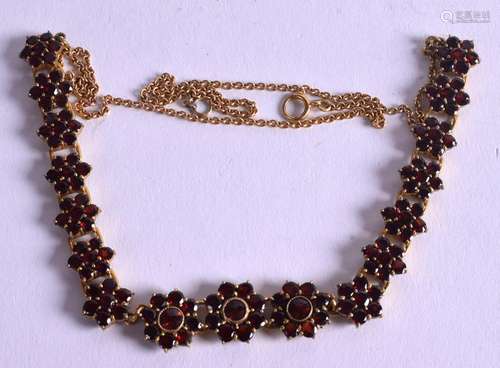 AN ANTIQUE YELLOW METAL AND GARNET NECKLACE. 13.5