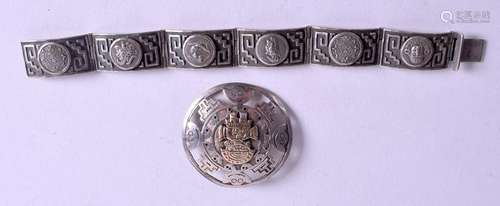 A SILVER BRACELET and a silver brooch. (2)