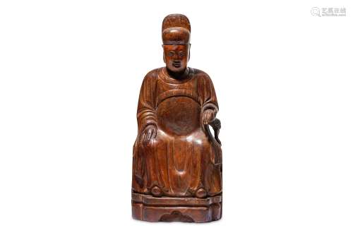 A CHINESE CYPRESS WOOD FIGURE OF A SEATED DIGNITAR