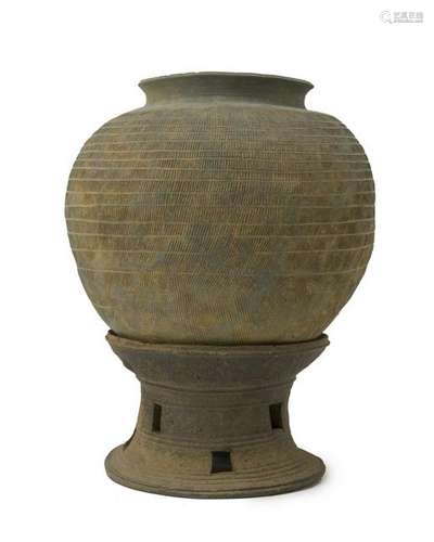 A gray pottery pot on stand