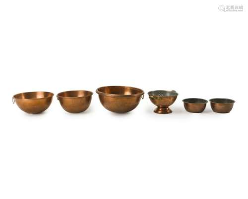 A group of copper cookware