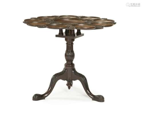 A carved mahogany tilt-top table