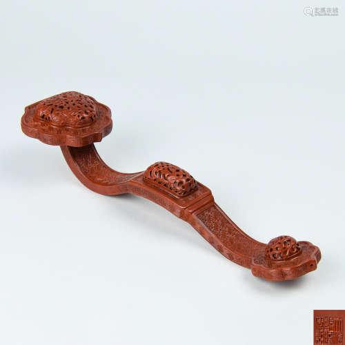A Chinese Carved Red Glazed Porcelain Ruyi
