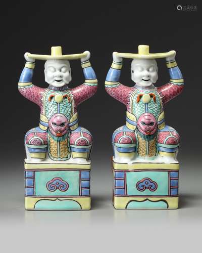 A pair of Chinese famille rose 'foreigner' candlesticks