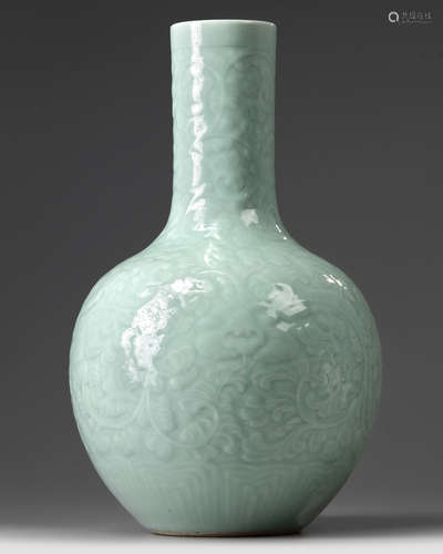 A Chinese carved and moulded celadon-glazed bottle vase