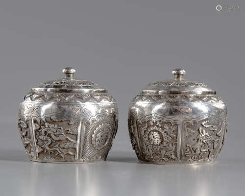 A pair of silver pots with cover