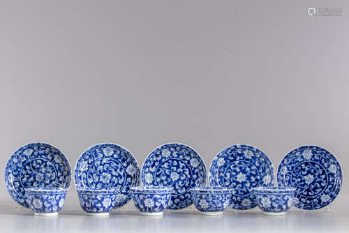 Five blue and white cups and seven saucers