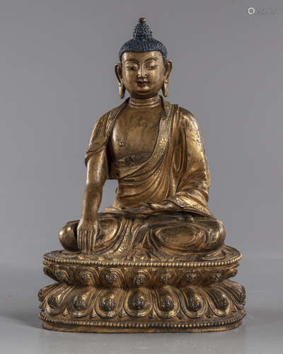 A gilt Chinese bronze figure of Buddha