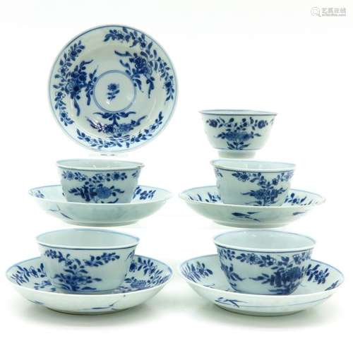 A Series of Five Blue and White Cups and Saucers