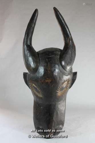 An African wooden mask carved as an antelope.