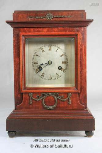 Wooden mantel clock with silvered dial, Junghans two train movement striking on a gong.