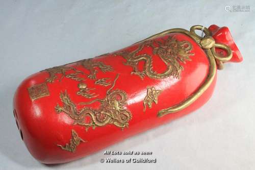 A Chinese red pottery pillow, 33cm long.