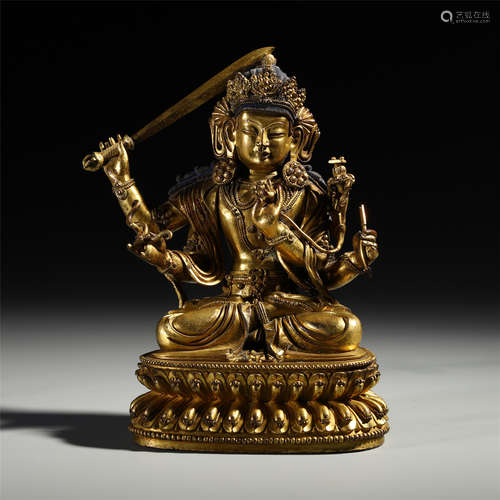 TIBETAN GILT BRONZE SEATED BUDDHIST GUARDIAN