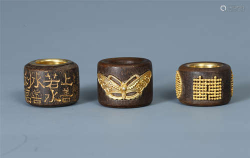 THREE CHINESE GILT SILVER AGALWOOD ARCHER'S RING