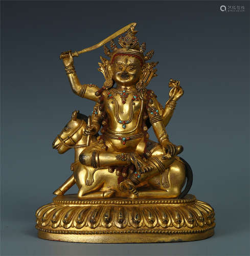 TIBETAN GILT BRONZE SEATED BUDDHIST GUARDIAN