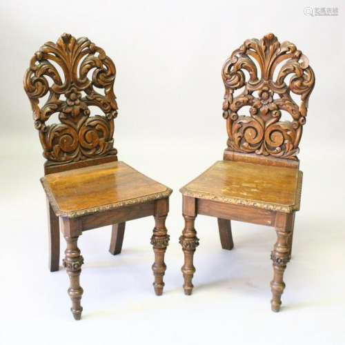 A PAIR OF VICTORIAN OAK HALL CHAIRS, with carved backs,