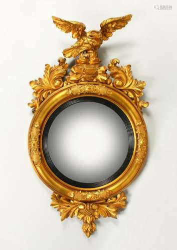 A REGENCY GILTWOOD CONVEX WALL MIRROR, with eagle