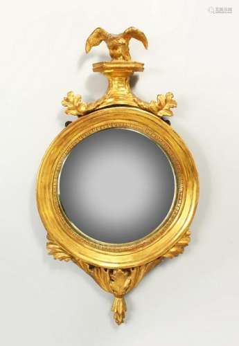 A SMALL REGENCY GILTWOOD CONVEX WALL MIRROR, with eagle