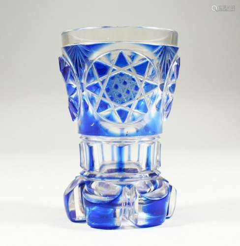 A BOHEMIAN BLUE TINTED BEAKER-VASE with cut base.  5ins