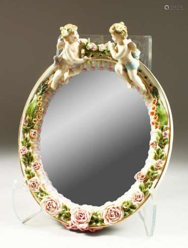 A MEISSEN STYLE OVAL MIRROR, with cherub and floral