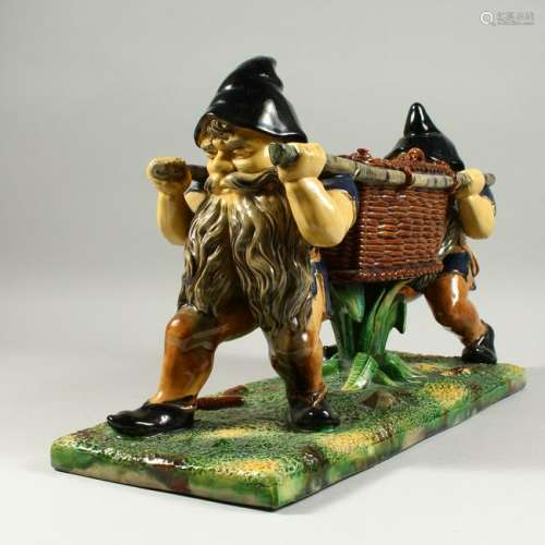 A LARGE MAJOLICA BASKET with two gnomes carrying a