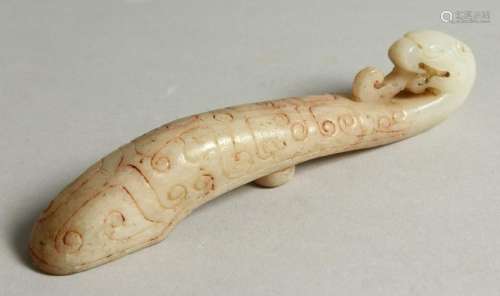 A CARVED WHITE JADE BELT HOOK.  16cms long.