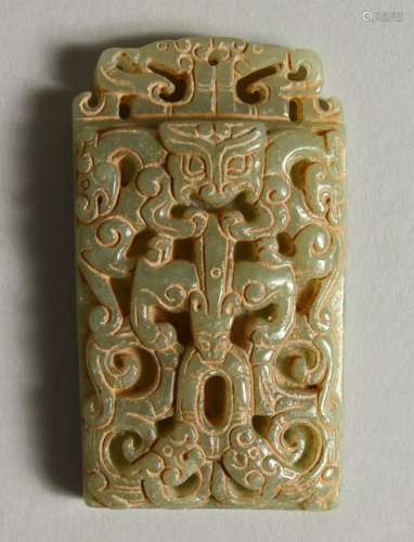 A CARVED AND PIERCED JADE PENDANT.  7cms high.