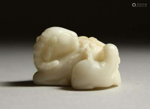 A SMALL WHITE JADE CARVING OF A RAM.  4cms long.