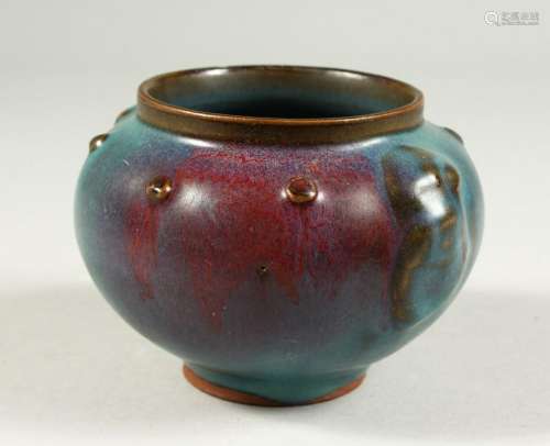 A PURPLE SPLASH TURQUOISE POTTERY BOWL.  13cms