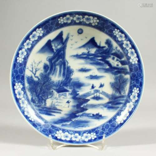 A CIRCULAR PLATE, decorated in blue and white with