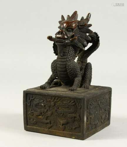 A LARGE BRONZE SEAL, with dragon handle.  18cms high.