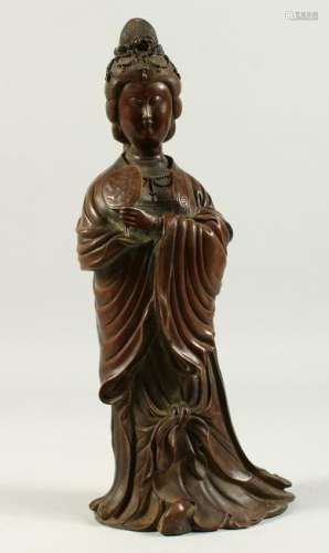 A BRONZE OF A STANDING LADY, holding a fan.  36cms