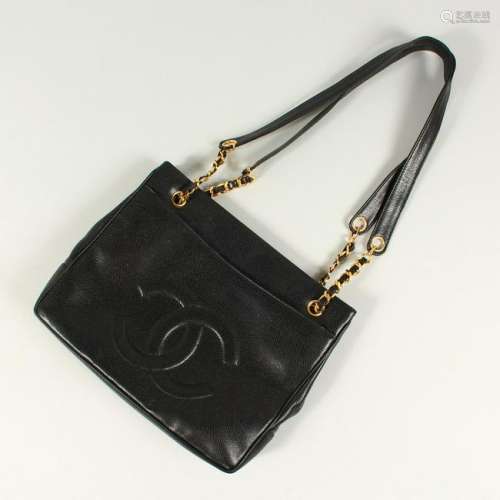 A BLACK LEATHER HANDBAG, with large embossed Chanel