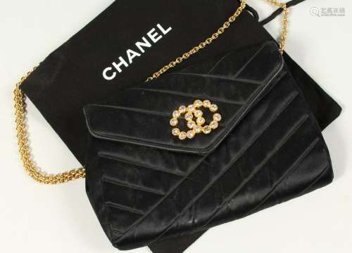 A SMALL BLACK QUILTED SATIN SHOULDER BAG, with diamante