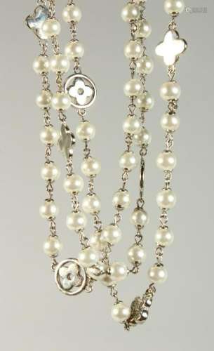 POSSIBLY CHANEL, a long pearl necklace, interspersed